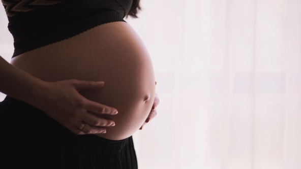 Pregnant woman holding her stomach
